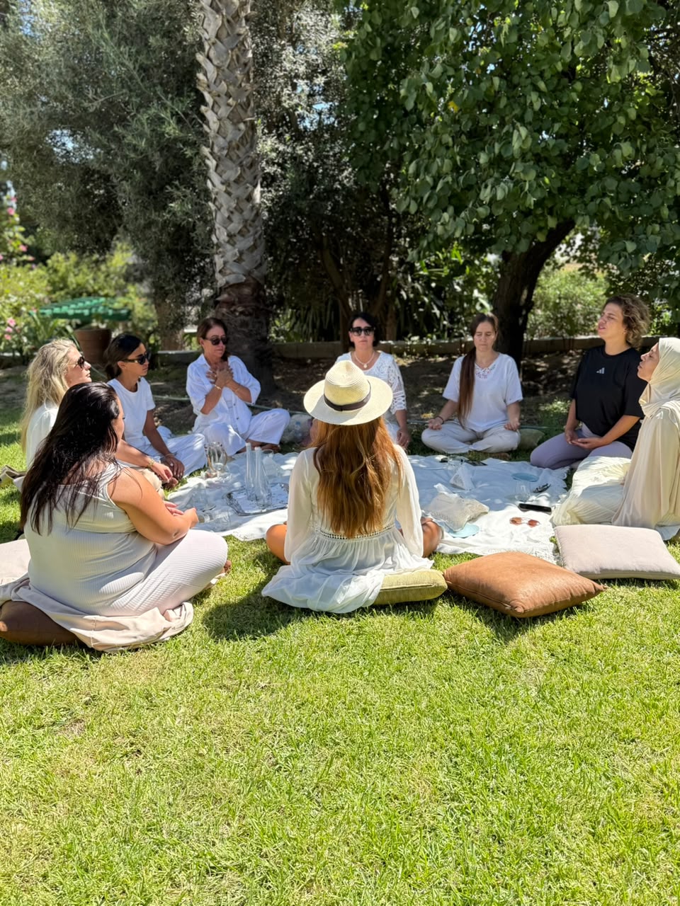 A group of women gathered outdoors for a guided breathing experience
